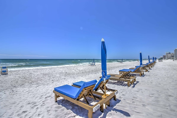 Relax on the beach with comfortable sun loungers and umbrellas.