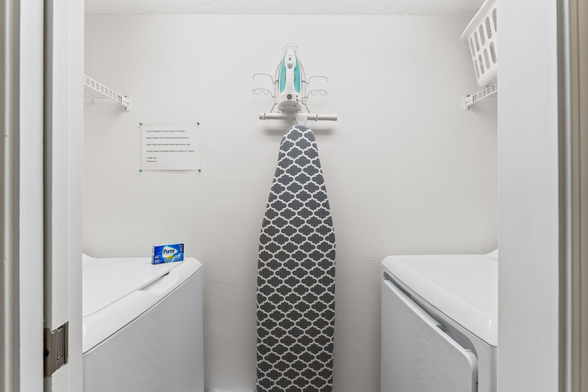 A small, white bathroom with a toilet, a sink, and a towel rack.