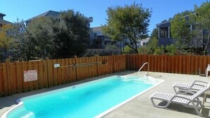 An outdoor swimming pool with a wooden fence, lounge chairs, and a sign indicating no diving. - OS756- 5 BRs, Private Pool, Hot Tub, Pool Table, Dog Friendly, Comm. Tennis! (Corolla)