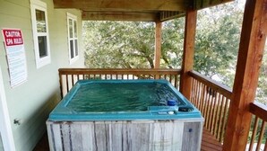 A hot tub on a wooden deck with a sign indicating spa rules. - OS756- 5 BRs, Private Pool, Hot Tub, Pool Table, Dog Friendly, Comm. Tennis! (Corolla)