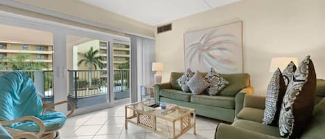 Living room open to the dining area with Gulf views through the windows