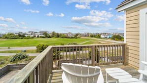 A wooden deck with a view of a golf course and residential houses in the background. - Pier Pressure At SandCastle Nags Head Village, Private Pool, On the Golf Course (Nags Head)