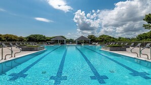 A rectangular swimming pool with clear blue water, surrounded by a wooden deck with lounge chairs and two gazebos. - Mayflower - Corolla, Ocean Sands, 250 Yds to Beach, Lake View, Pool, Hot Tub, Flex Stays (Corolla)