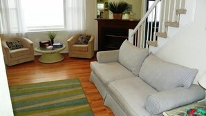 A living room with a sofa, two armchairs, a coffee table, and a striped rug. - KH5203- Oceanfront With Two Masters, Hot Tub, Covered Porch and Dog Friendly! (Kitty Hawk)
