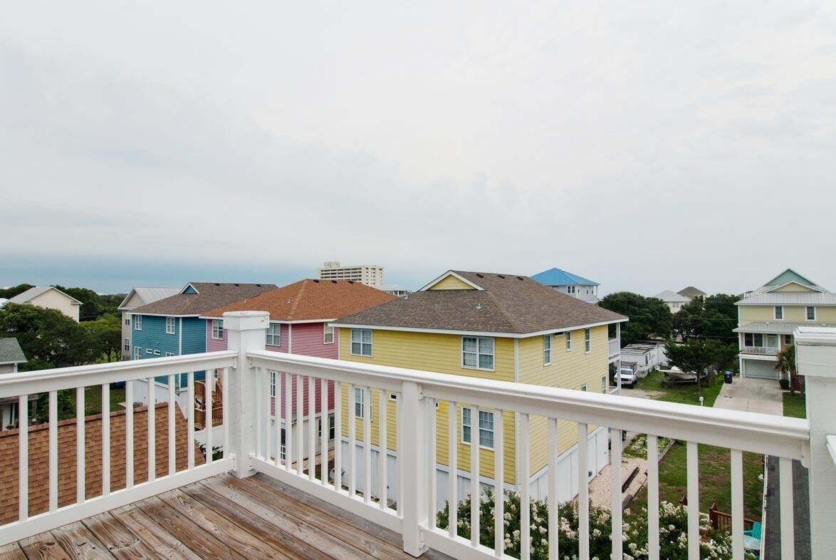 A residential area with colorful houses and a wooden deck.