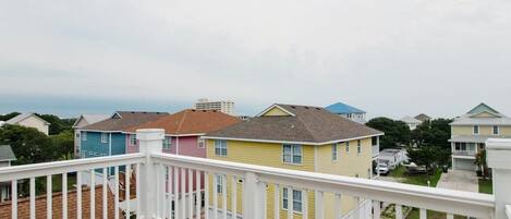 A residential area with colorful houses and a wooden deck.