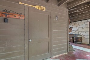 A closed door with a sign reading "Paddles & Laundry" and a no-socks-on-the-floor sign. - The Creek,The Pool, walking distance to the square it's all here! (Wimberly)