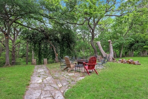 A stone pathway leading to a seating area with Adirondack chairs and a fire pit. - The Creek,The Pool, walking distance to the square it's all here! (Wimberly)