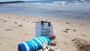 A beach scene with a bag labeled "COCKTAILS RELAXATION VACATION."