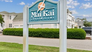 A sign for Mai Kai Condominiums with a clear view of the surrounding residential area.