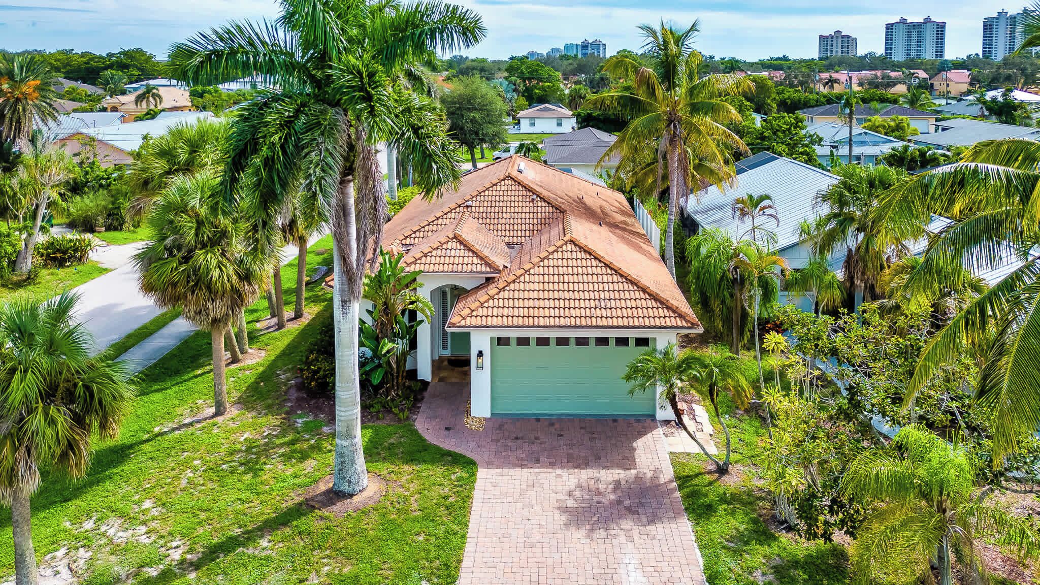 Exterior of Neapolitan Vacation Rental; Beautiful Tropical Landscape; Just 8 Minutes to Vanderbilt Beach! 