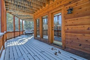 Relax on the deck with a bench and dining table, taking in the serene views of the surrounding forest.