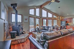 Relax in a spacious living area with a fireplace, sofa, and dining table.