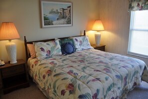 Cozy retreat with a large bed, bedside tables, and a framed picture above.