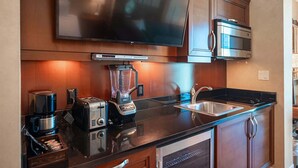 A modern kitchen with a built-in microwave, toaster, blender, and coffee maker. - No Resort Fee Strip View Suite + Free Valet + Pool (Las Vegas)