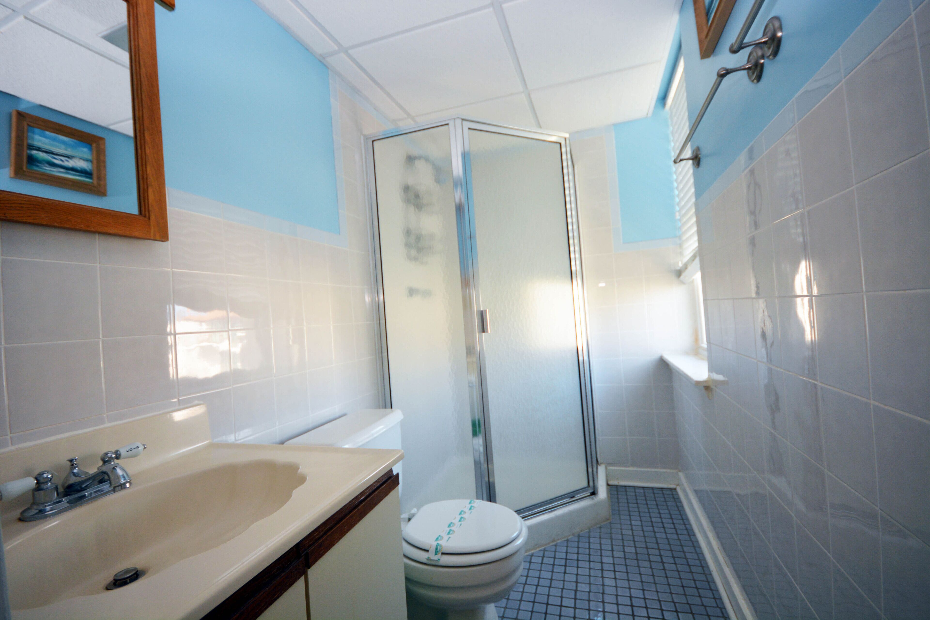 A bathroom with a sink, toilet, and shower.