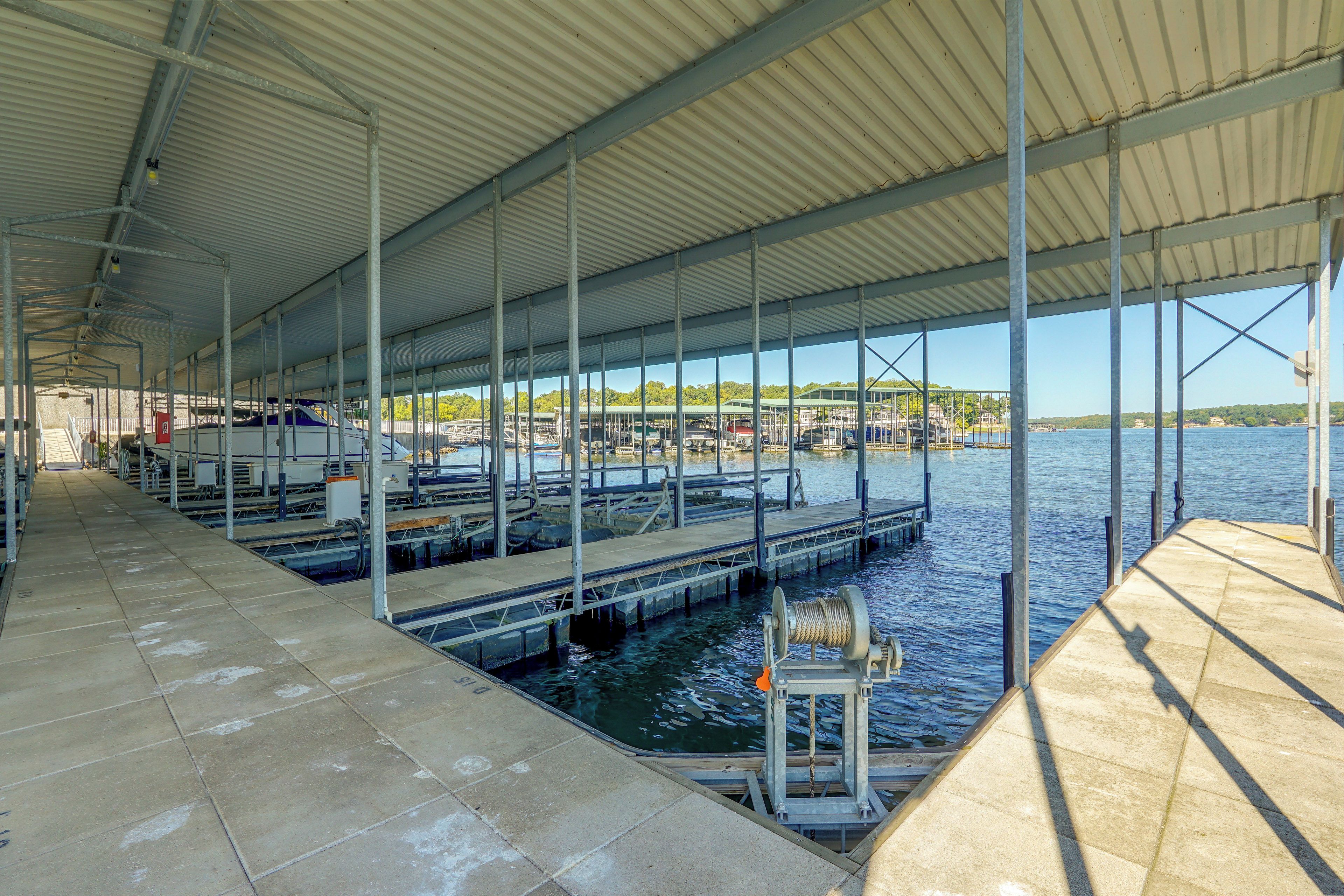 A covered marina with multiple docks and boats.