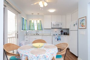 Enjoy meals in the kitchen with a dining area for four, featuring a microwave, stove, and refrigerator.
