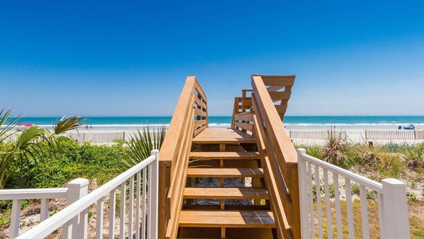 A wooden boardwalk leading to a beach with white railings. - *Fall into Savings-20% Off New Bookings thru 2026* (Surfside Beach)