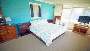 A bedroom with a bed, dresser, bedside table, lamp, fan, and TV. - SN9017D- Semi-OF!  With 3 BRs, Direct Beach Access, Private and Secluded! (Nags Head)