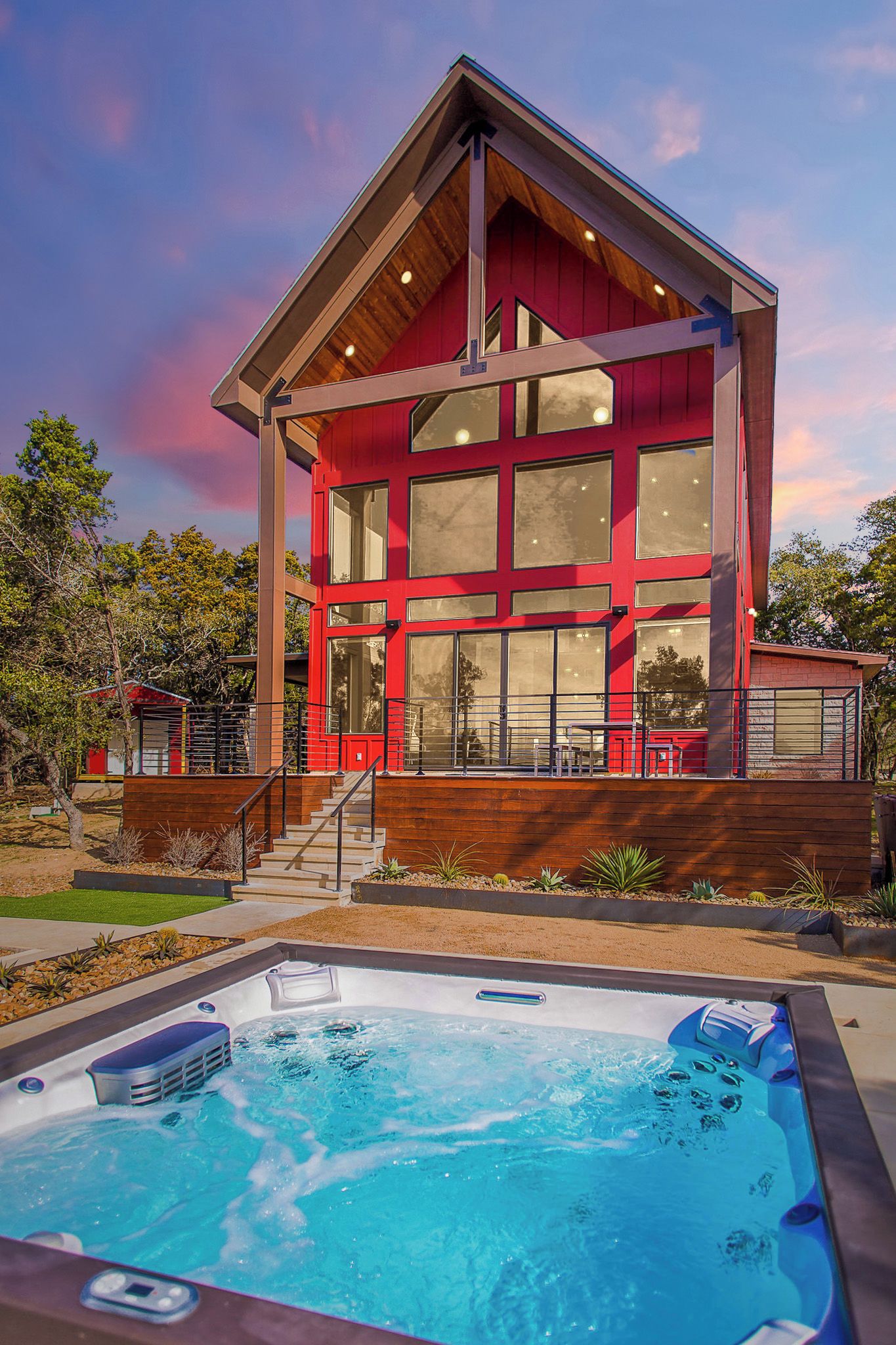 A modern house with a hot tub in front.