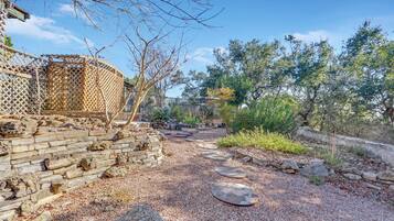 A garden pathway with stone steps and a wooden fence.