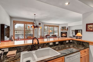 Enjoy cooking in this well-equipped kitchen with a large island, sink, and dishwasher.
