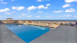 A pool area with a view of the beach, lounge chairs, and a wooden deck. - *Fall into Savings-20% Off New Bookings thru 2026* (Garden City)