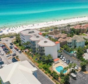 A resort with multiple buildings, a swimming pool, and a beach in the background. - Dog Friendly, Gorgeous Water Views, Beach Service, Pool (Miramar Beach)