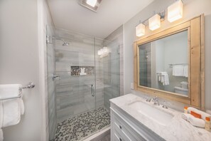 Bathtub, hair dryer, towels, shampoo