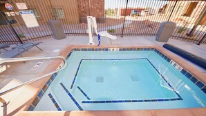 A swimming pool with a diving board, a lifeguard chair, and a fence. - Red Cliffs Condos - 3E, 3 Bed Condo With Stunning (Moab)
