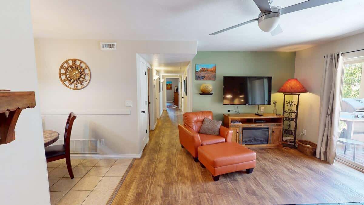 A living room with a sofa, a television, and a fireplace.