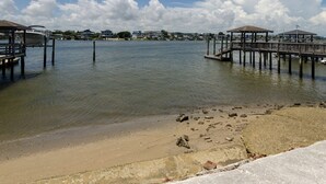 A waterfront area with docks and a beach.