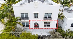 A white building with a central entrance, multiple windows, and balconies. - South of Fifth 1BR Condo - Heated Pool, Balcony & Walk to Beach (Miami Beach)