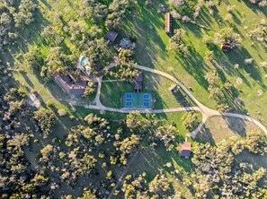 Aerial view of the ranch - 10 Bedroom Hill Country Retreat with Pickleball, Tennis and Pool- Stonehaven Ran (San Marcos)