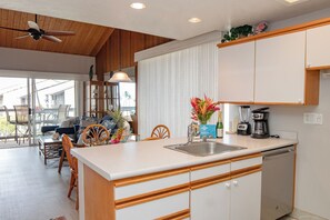 A kitchen with a central island, wooden cabinets, a dishwasher, and a ceiling fan. - Hale Kamaole 245  Second floor condo, easy access to best beach on Maui! (Kihei)