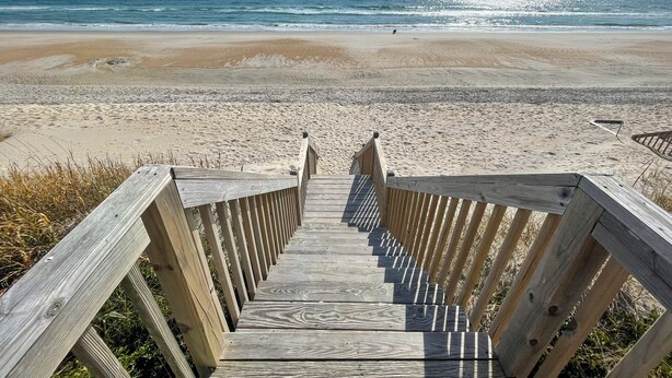 A wooden boardwalk leading to a beach with a clear view of the ocean. - Island Delights II – Sun, Sand & Simple Fun (Surf City)