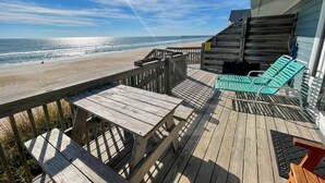 A wooden deck with a view of the beach and ocean. - Island Delights II – Sun, Sand & Simple Fun (Surf City)