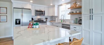 Experience coastal living at its finest in this spacious upstairs unit just steps from the sand!