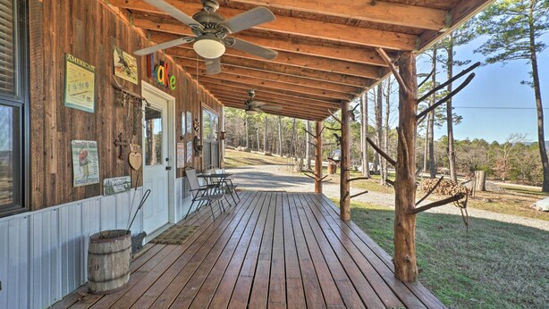 A wooden porch with a ceiling fan, a wooden barrel, and a sign that reads "lake". - 'Sardis Serenity' 1 BR Clayton Cabin w/ Lake View (Clayton)
