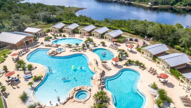 A resort with multiple swimming pools, lounge areas, and a view of a large body of water. - Penthouse, Private Master Balcony, Gulf and Dune Lake Views (Santa Rosa Beach)