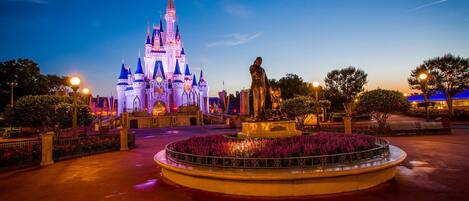 A castle-like structure with a statue in the foreground.