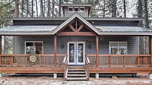 A two-story house with a front porch, wooden railings, and a logo on the door. - 1 Mi to Mtn, 1 More to Shore! Luxury Tahoe Home (South Lake Tahoe)