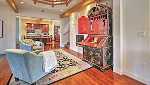 A spacious living room with a high ceiling, a staircase, and a kitchen in the background. - 1 Mi to Mtn, 1 More to Shore! Luxury Tahoe Home (South Lake Tahoe)