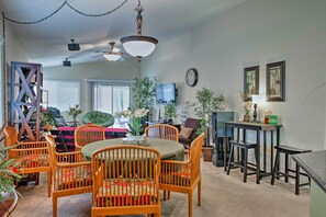 A dining area with a round table and chairs, a ceiling fan, and a television on the wall. - Gated Community Home w/ Patio, 9 Mi to Vegas Strip (Las Vegas)