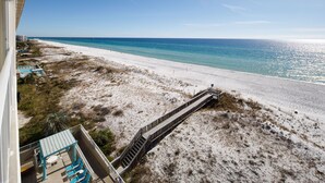 A beach view from a balcony with a wooden walkway leading to the shore. - Gulf Dunes 617: Sand Dollar Daze - Marvelous 3 bed, 3 bath unit! A must see! (Fort Walton Beach)