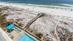 A beach view with a swimming pool, beach chairs, and umbrellas. - Gulf Dunes 617: Sand Dollar Daze - Marvelous 3 bed, 3 bath unit! A must see! (Fort Walton Beach)