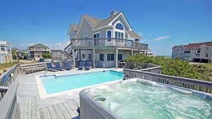 A large house with a swimming pool and a hot tub on a wooden deck. - OH1200- 5 BRs with 2 Masters, Private Pool, Hot Tub, Foosball and Volleyball! (Corolla)
