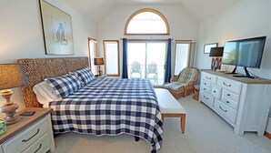 A bedroom with a large bed, a television, a desk, and a chair. - OH1200- 5 BRs with 2 Masters, Private Pool, Hot Tub, Foosball and Volleyball! (Corolla)