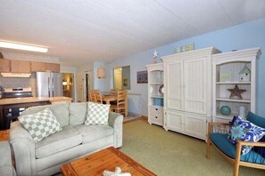 Relax in this well-appointed living space with a sofa, coffee table, and dining area.